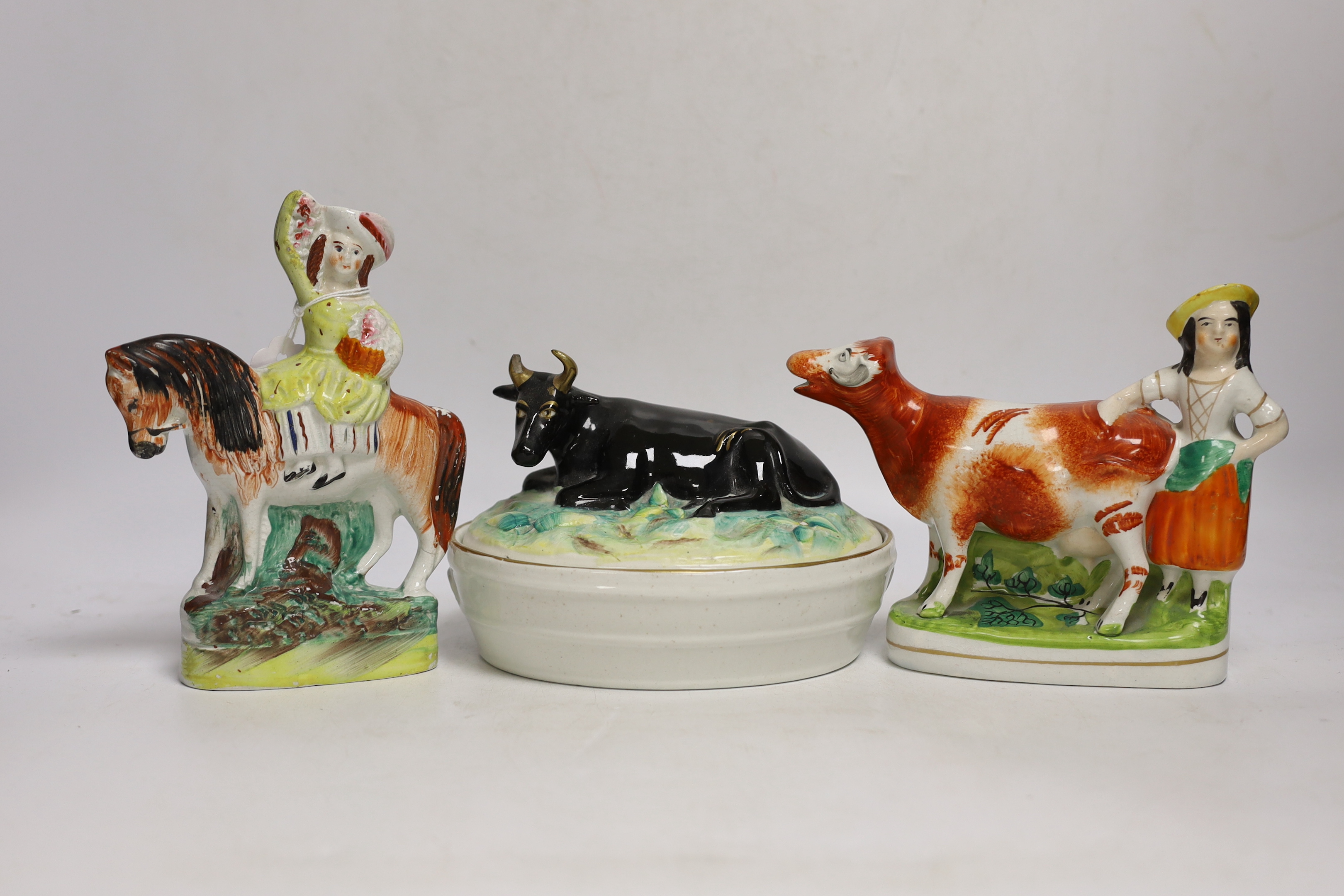 A Victorian Staffordshire cow tureen and cover, and five other Staffordshire figures, largest 18cm wide